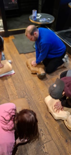 Delegates practising CPR on adult manikins during a workplace first aid session