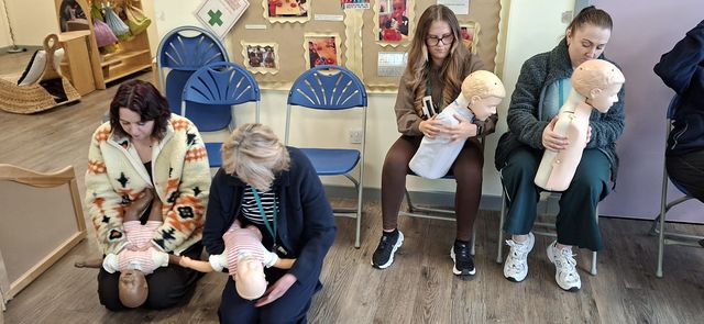 Paediatric first aid training in progress with infant and child manikins
